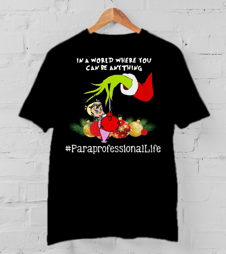 In A World Where You Can Be Anything Hand Grinch Holding Ornaments #ParaprofessionalLife T-Shirt