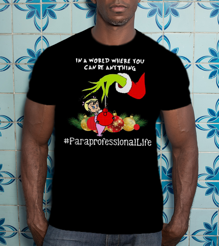 In A World Where You Can Be Anything Hand Grinch Holding Ornaments #ParaprofessionalLife T-Shirt