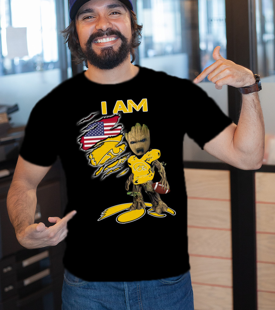 I Am Hawkeyes Baby Groot Holding Football With Usa Flag And Iowa Hawkeyes T-Shirt