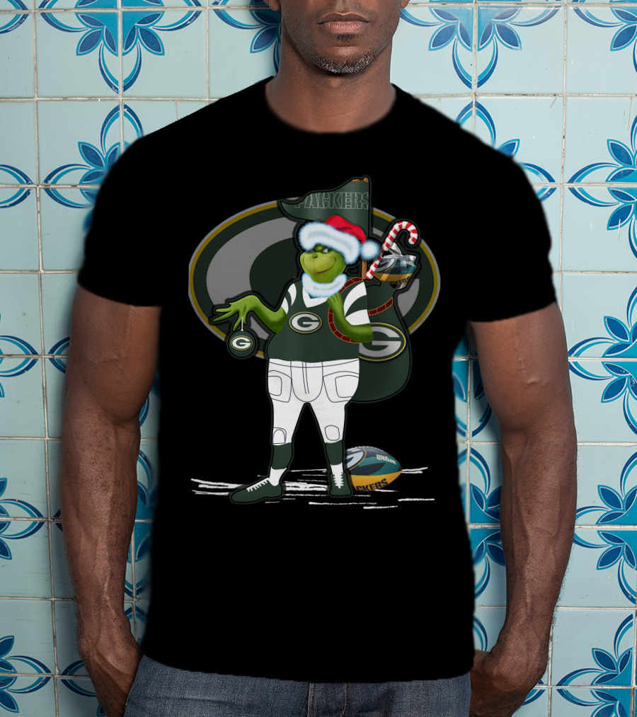 Grinchxmas Green Bay Packers Santa Hat Grinch Holding Helmet And Candy Cane T-Shirt
