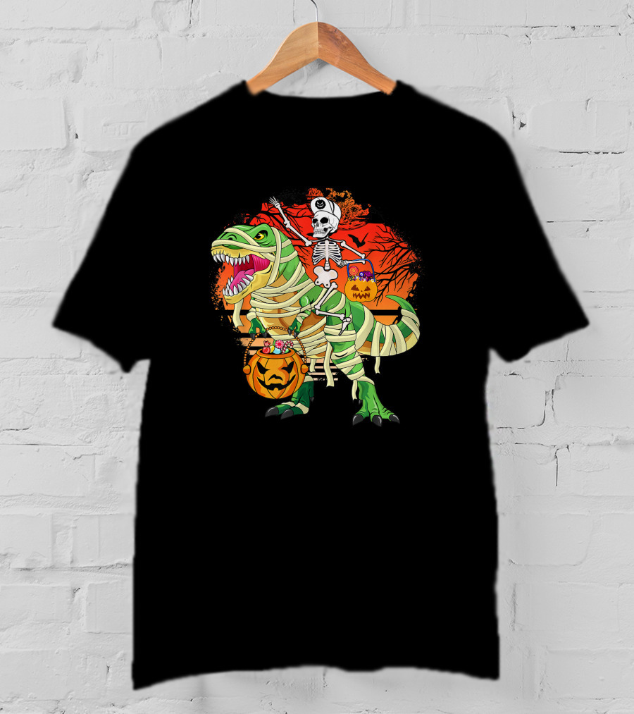 Skeleton Riding Mummy Dinosaur Rex With Halloween Pumpkins On Spooky Background T-Shirt
