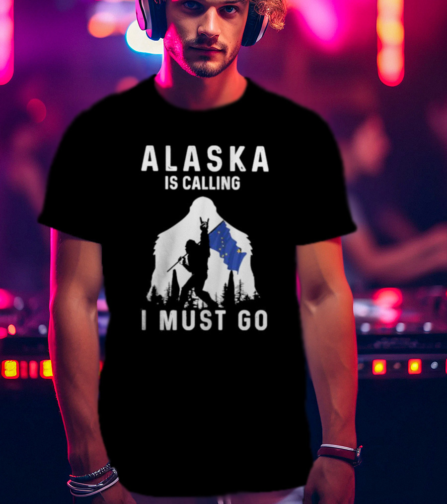 Alaska Is Calling I Must Go Bigfoot Holding Alaska Flag T-Shirt