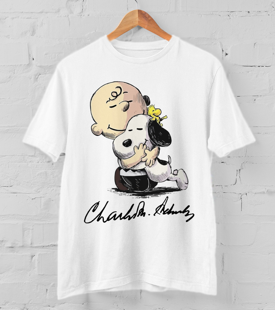 Snoopy And Charlie Brown Hugging By Charles M. Schulz T-Shirt