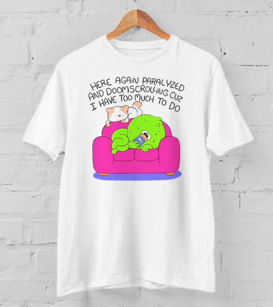 Here Again Paralyzed And Doomscrolling Cuz I Have Too Much To Do Quirky Green Figure Relaxing On Pink Couch With Cute Dog T-Shirt