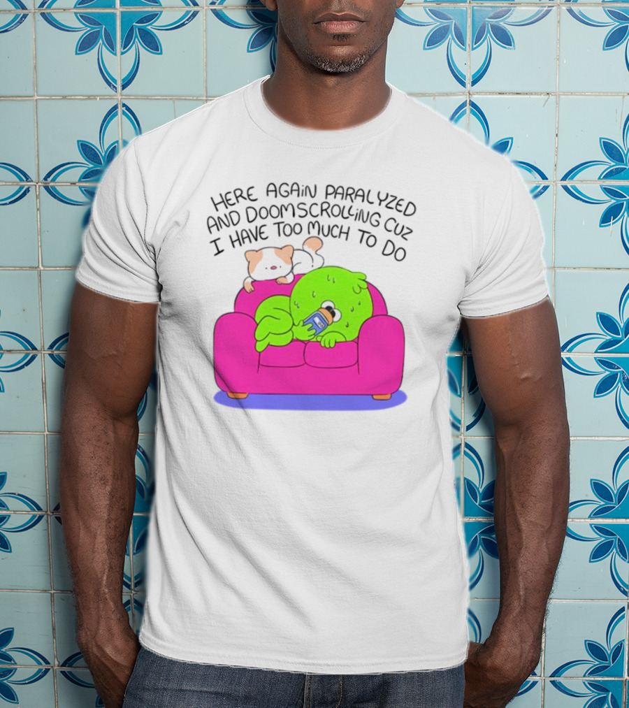 Here Again Paralyzed And Doomscrolling Cuz I Have Too Much To Do Quirky Green Figure Relaxing On Pink Couch With Cute Dog T-Shirt