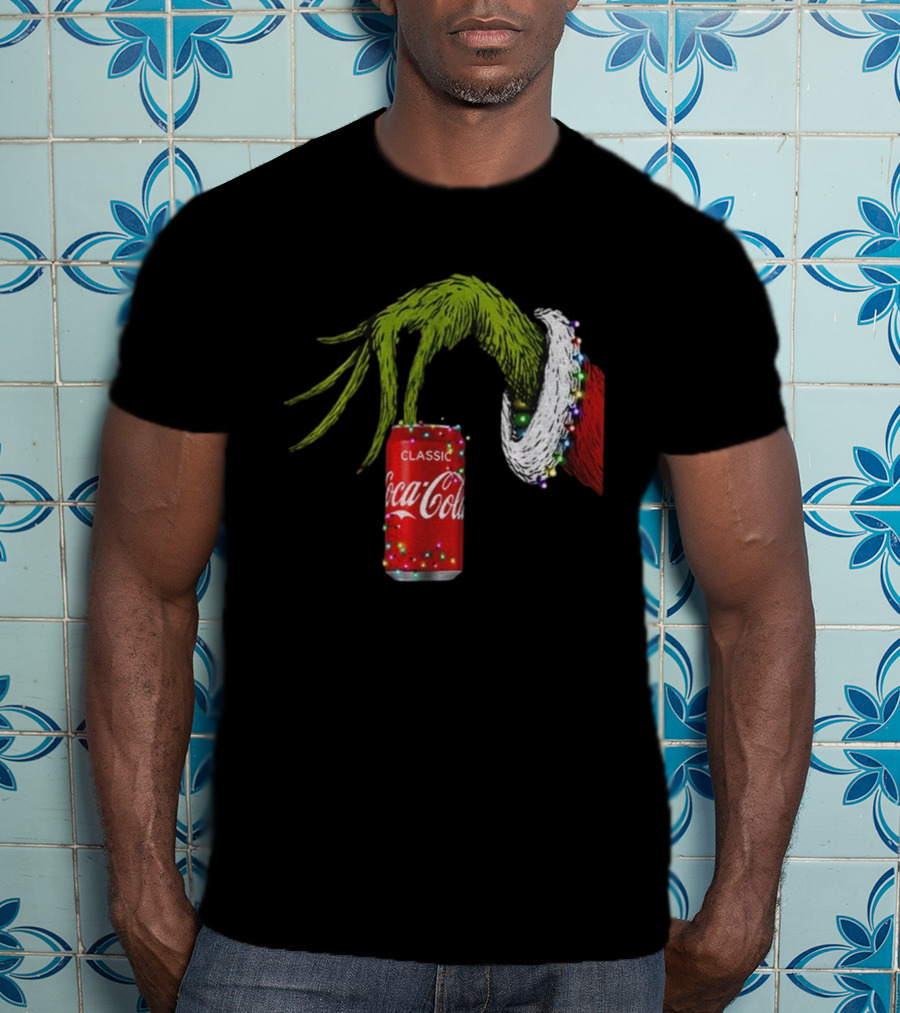 Grinch Hand Holding Coca-Cola Can Wrapped In Christmas Lights Merry Christmas T-Shirt