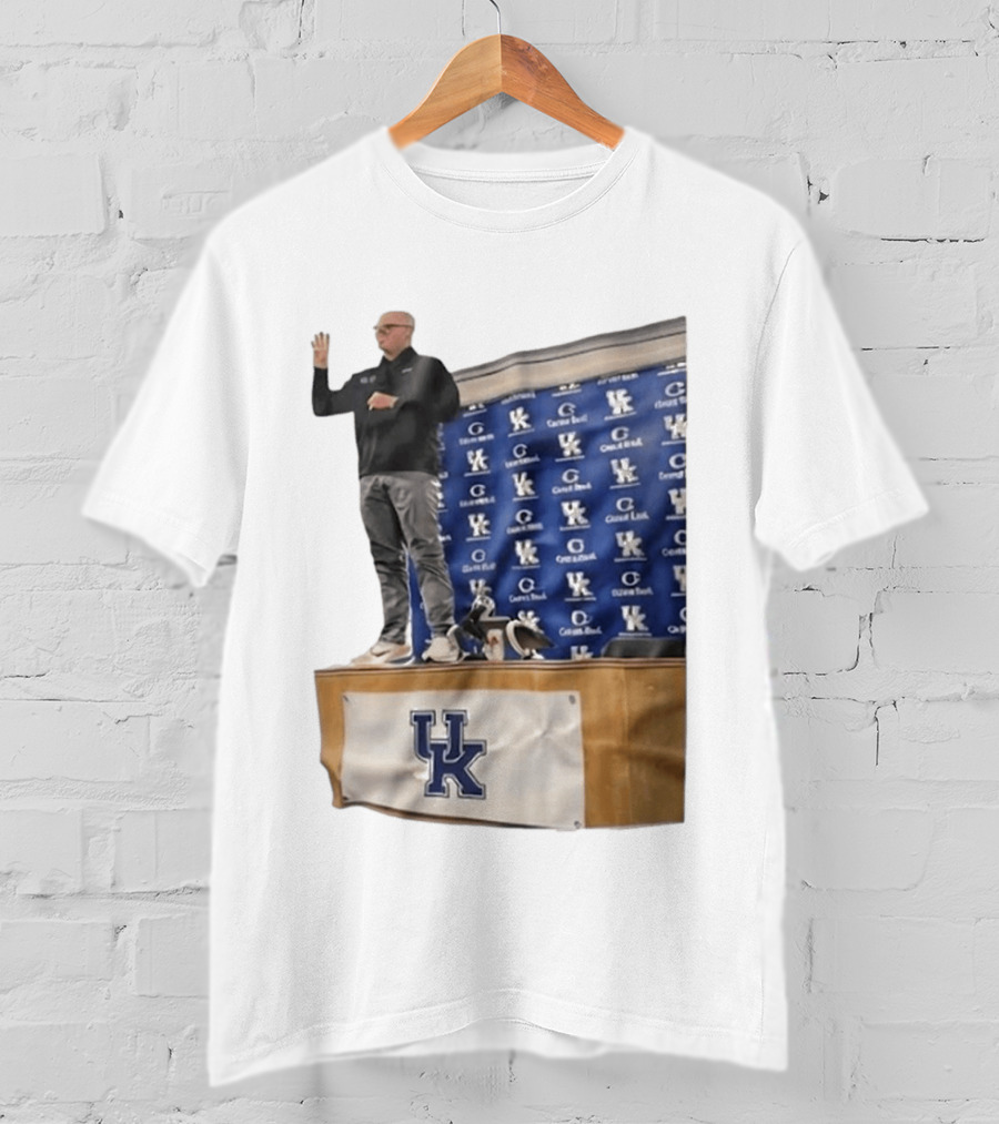 UK Volleyball Coach Craig Skinner Standing On Table With UK Logo And Awards T-Shirt