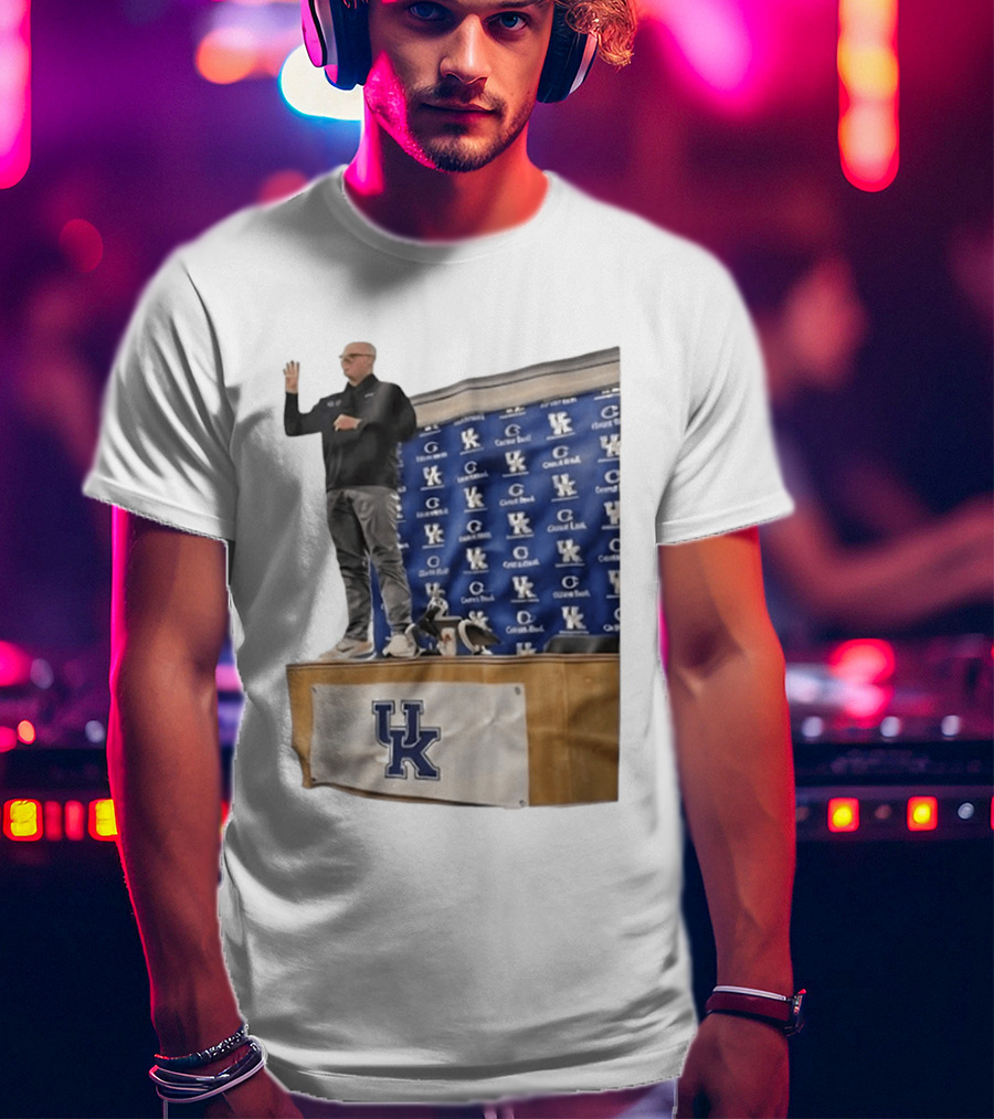 UK Volleyball Coach Craig Skinner Standing On Table With UK Logo And Awards T-Shirt