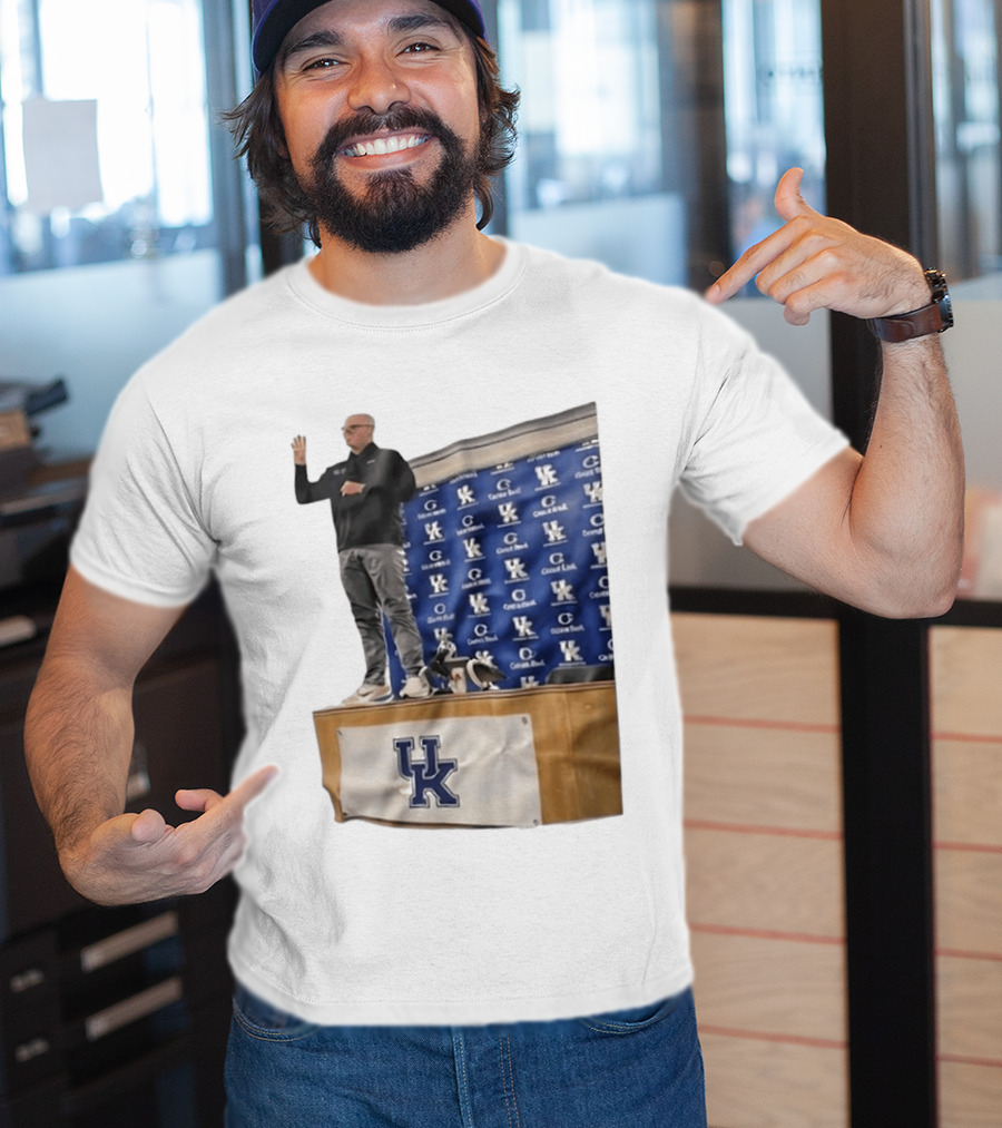 UK Volleyball Coach Craig Skinner Standing On Table With UK Logo And Awards T-Shirt