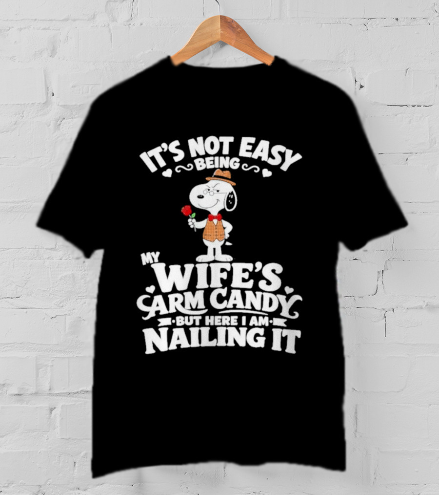 Snoopy It's Not Easy Being My Wife's Arm Candy But Here I Am Nailing It T-Shirt