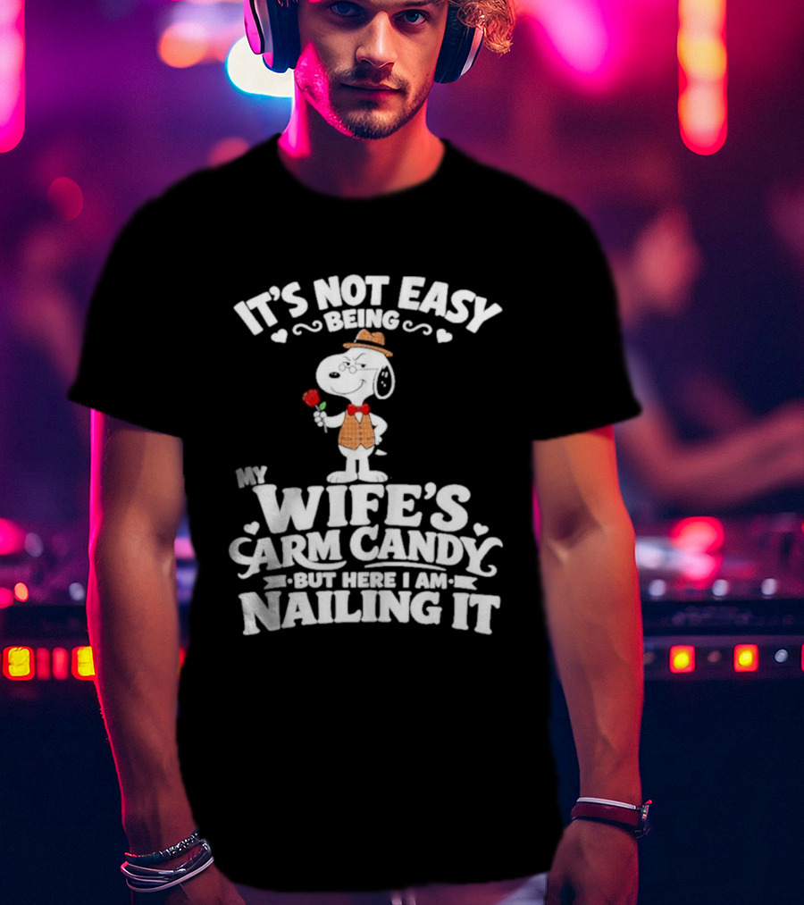 Snoopy It's Not Easy Being My Wife's Arm Candy But Here I Am Nailing It T-Shirt
