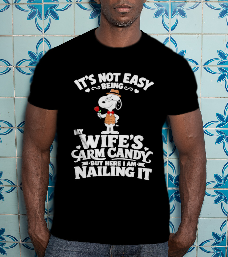 Snoopy It's Not Easy Being My Wife's Arm Candy But Here I Am Nailing It T-Shirt