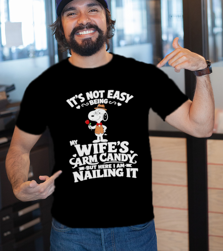 Snoopy It's Not Easy Being My Wife's Arm Candy But Here I Am Nailing It T-Shirt