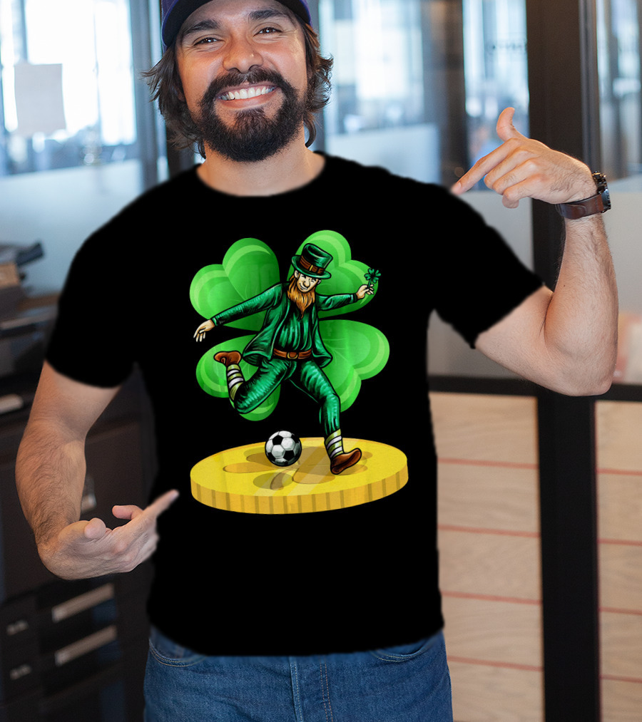 Leprechaun Kicking Soccer Ball On Gold Coin With Shamrock Background T-Shirt