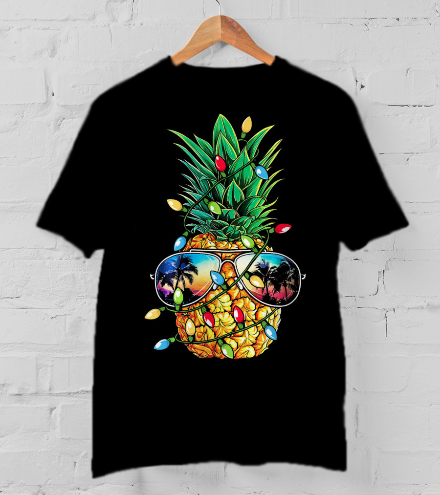 Pineapple Wrapped In Christmas Lights With Sunglasses Reflected Sunset And Palm Trees T-Shirt