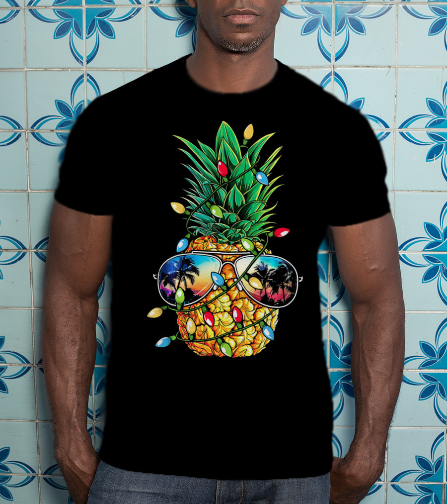 Pineapple Wrapped In Christmas Lights With Sunglasses Reflected Sunset And Palm Trees T-Shirt
