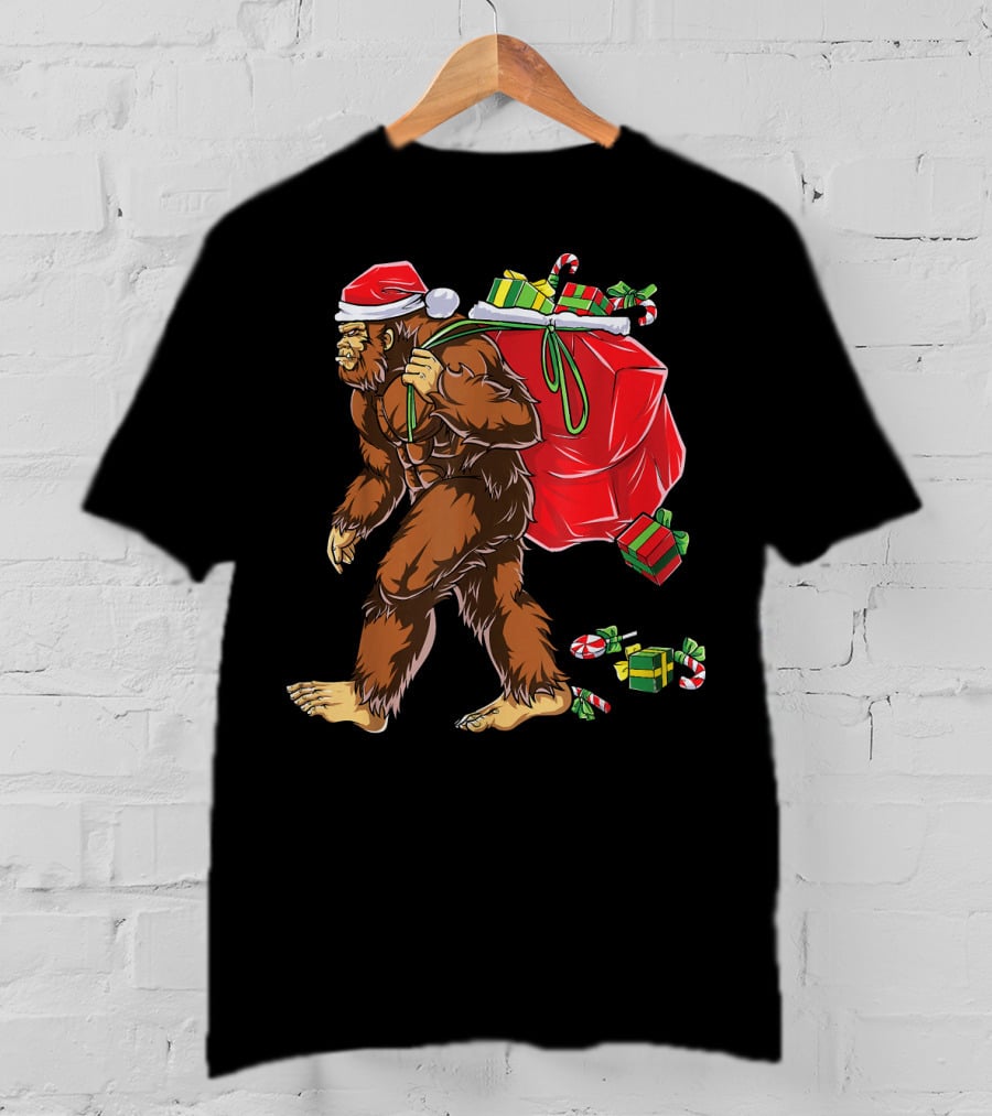 Bigfoot Santa Hat Carrying Christmas Presents And Candy Canes T-Shirt