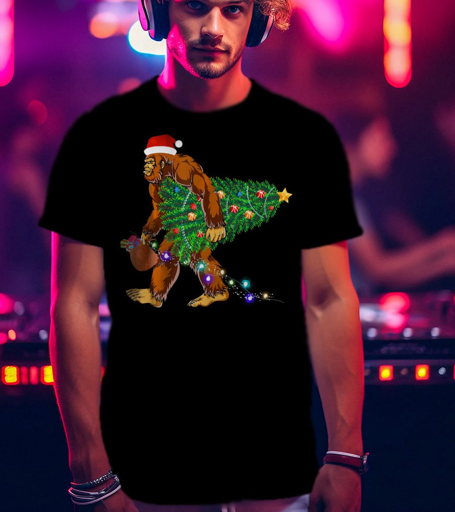 Santa Hat Bigfoot Holding Christmas Tree With Lights And Gifts T-Shirt