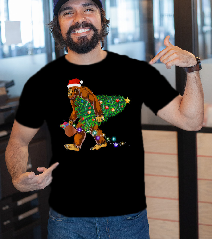 Santa Hat Bigfoot Holding Christmas Tree With Lights And Gifts T-Shirt