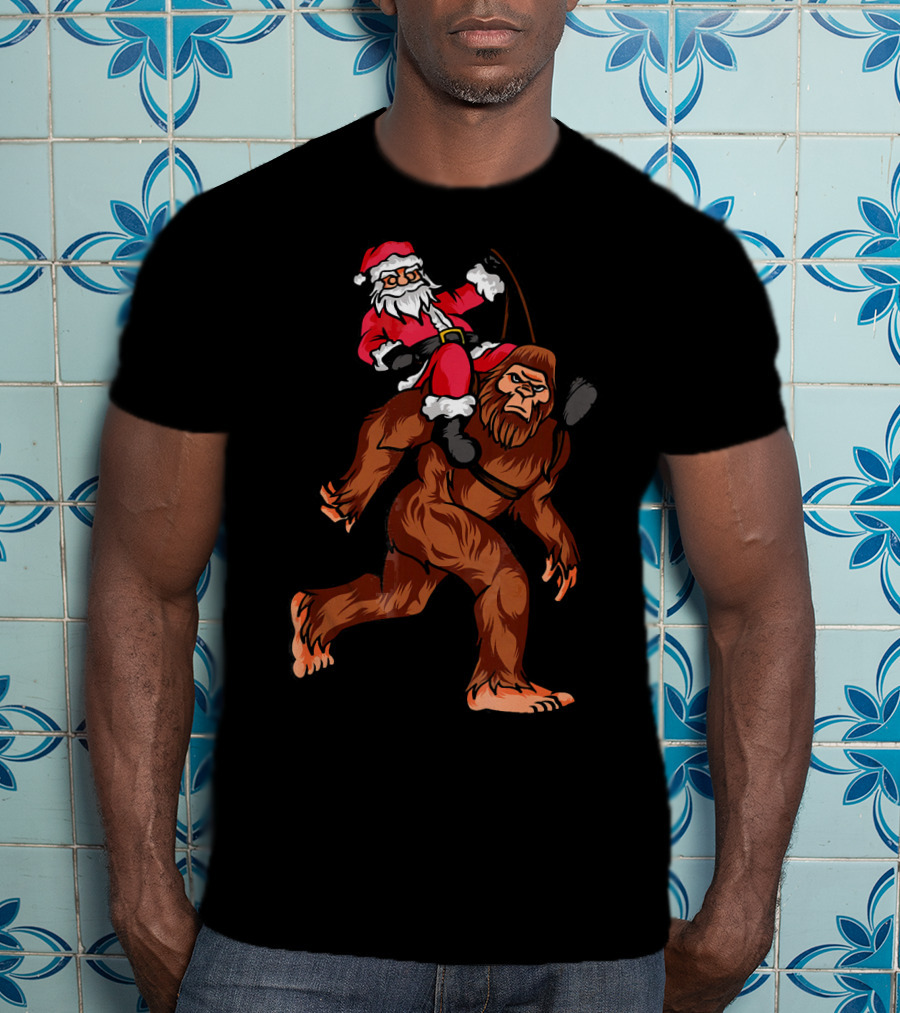 Bigfoot Carrying Santa Claus In Christmas T-Shirt