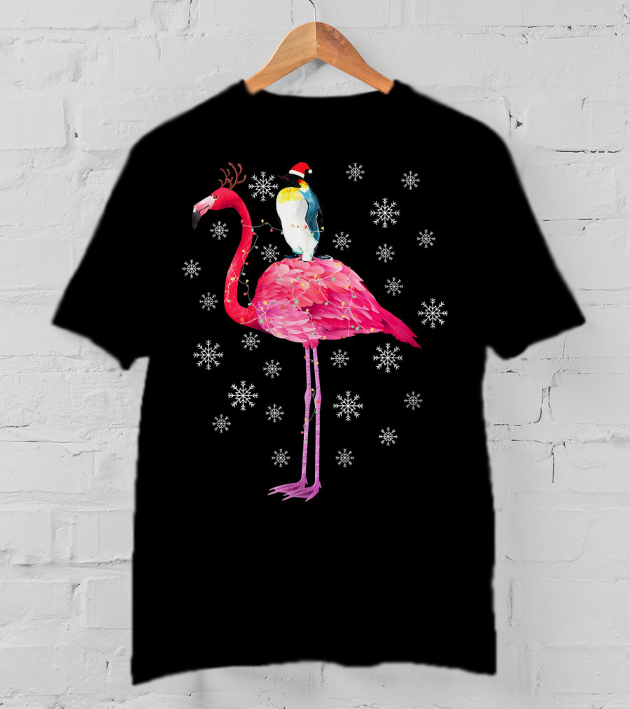 Penguin With Santa Hat Riding Flamingo With Antlers Surrounded By Snowflakes T-Shirt