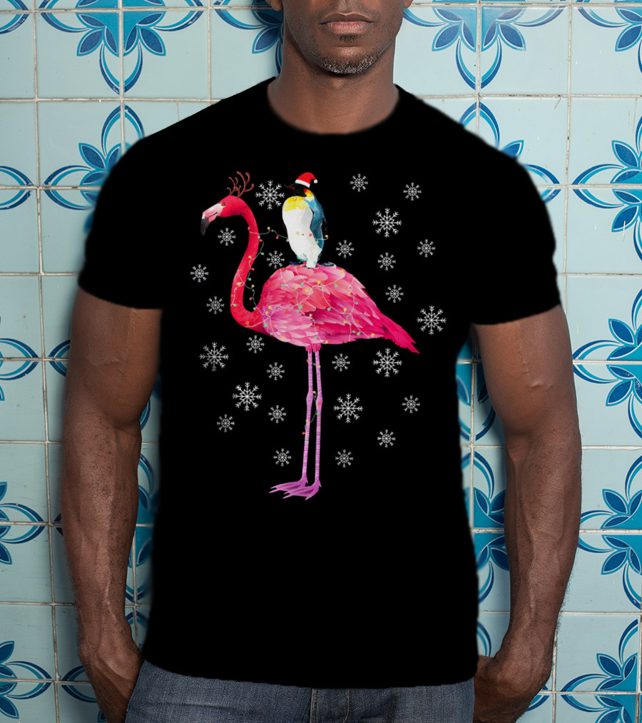 Penguin With Santa Hat Riding Flamingo With Antlers Surrounded By Snowflakes T-Shirt